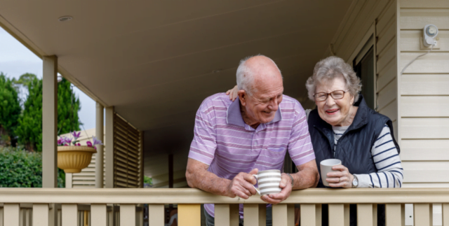Two smiling senior citizens enjoying each other's company outdoors, representing the benefits of nano-emulsified CBD for elderly well-being.